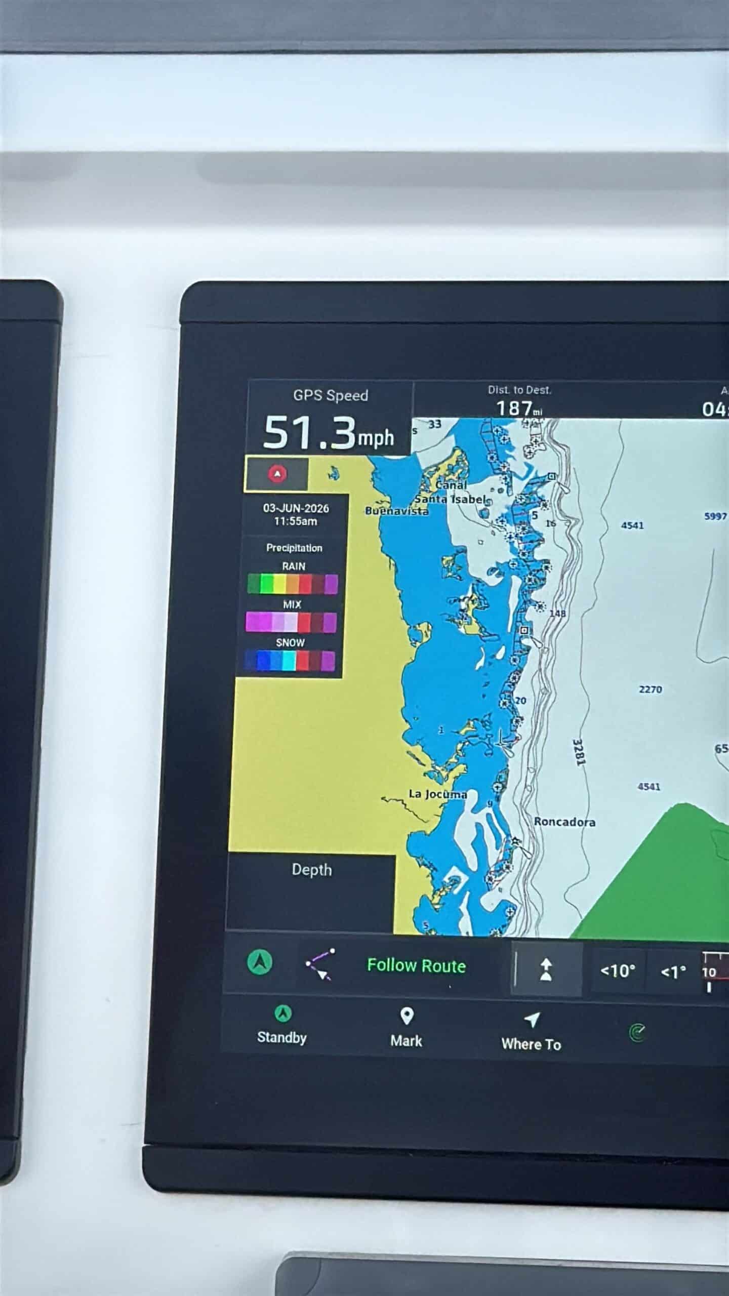 Marine GPS display showing current speed 51.3 mph, with a color-coded coastal map, depth contours, and a weather/precipitation legend (RAIN, MIX, SNOW); bottom controls read Follow Route, Standby, Mark, etc.